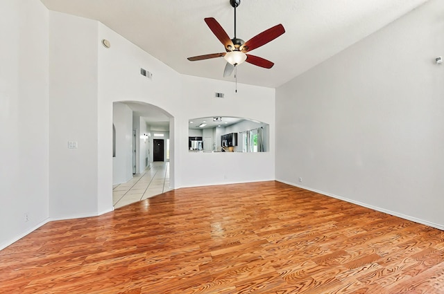 4954 Dream Dancer Dr NE, Rio Rancho, NM 87144 - unfurnished living room with visible vents, arched walkways, light wood-style floors, and ceiling fan