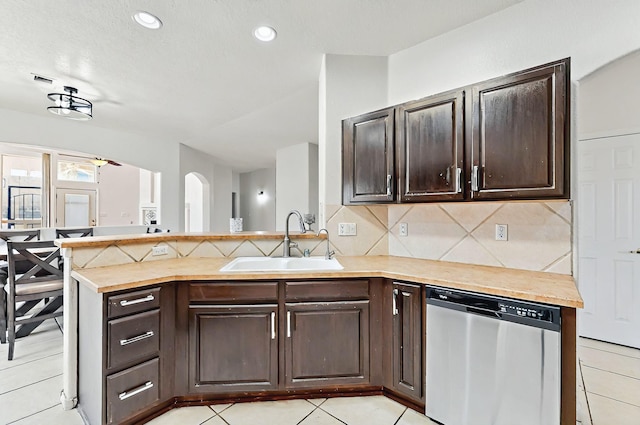4954 Dream Dancer Dr NE, Rio Rancho, NM 87144 - kitchen with decorative backsplash, a peninsula, dark brown cabinetry, a sink, and dishwasher