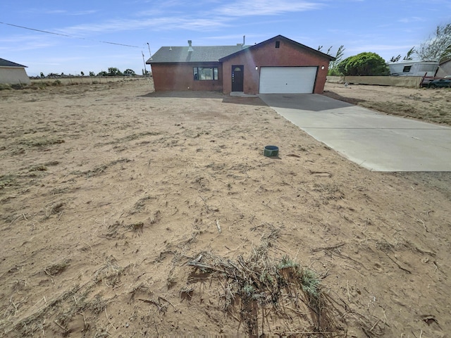 ranch-style house featuring an attached garage and driveway