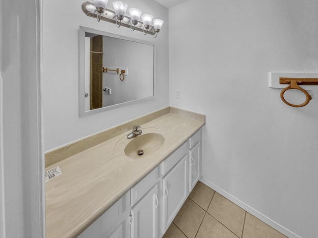 bathroom featuring tile patterned floors, baseboards, and vanity