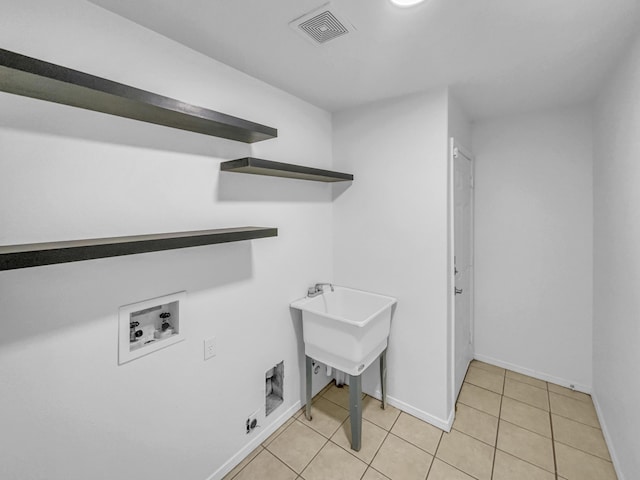 laundry area with laundry area, hookup for a washing machine, baseboards, light tile patterned floors, and visible vents