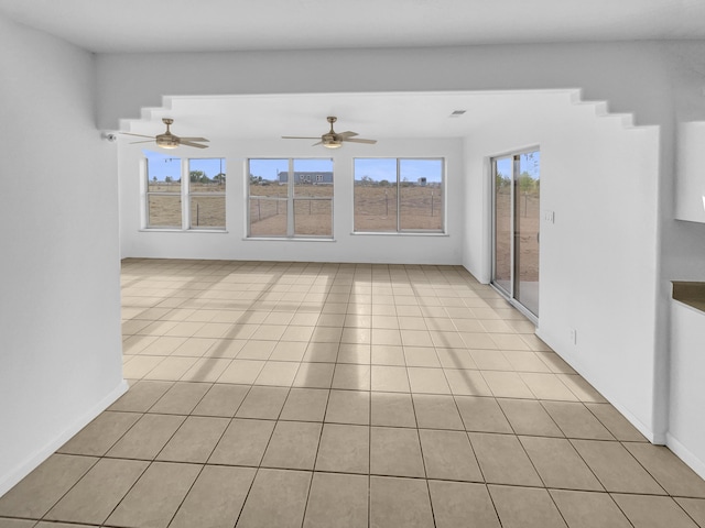 unfurnished living room featuring ceiling fan and light tile patterned floors
