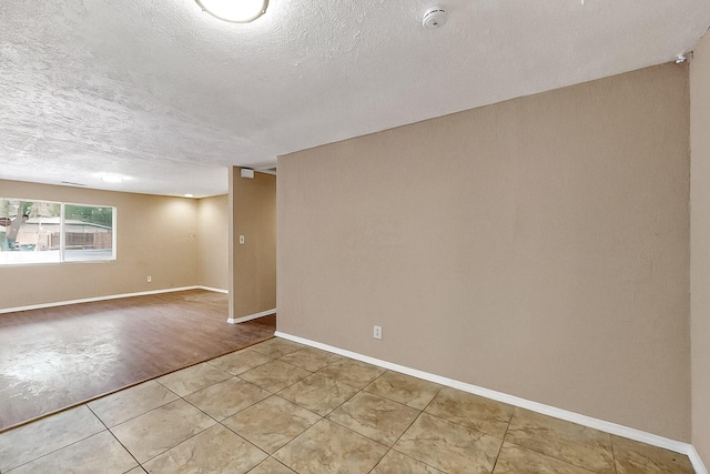 7121 Isleta Blvd SW Rear, Rear, Albuquerque, NM 87105 - unfurnished room featuring a smoke detector, a textured ceiling, light tile patterned floors, and baseboards