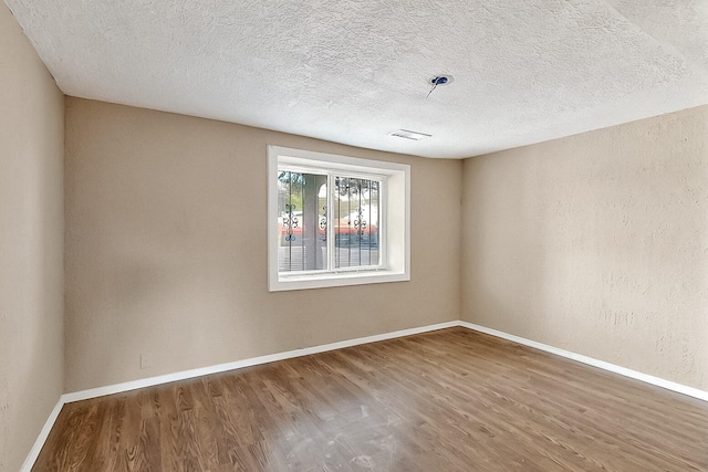 7121 Isleta Blvd SW Rear, Rear, Albuquerque, NM 87105 - spare room with wood finished floors, baseboards, and a textured ceiling