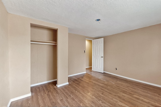 7121 Isleta Blvd SW Rear, Rear, Albuquerque, NM 87105 - unfurnished bedroom with wood finished floors, a textured ceiling, a closet, and baseboards