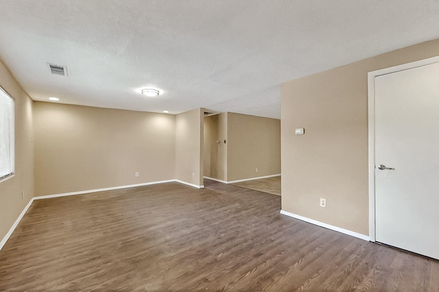 7121 Isleta Blvd SW Rear, Rear, Albuquerque, NM 87105 - empty room with wood finished floors, baseboards, and a textured ceiling