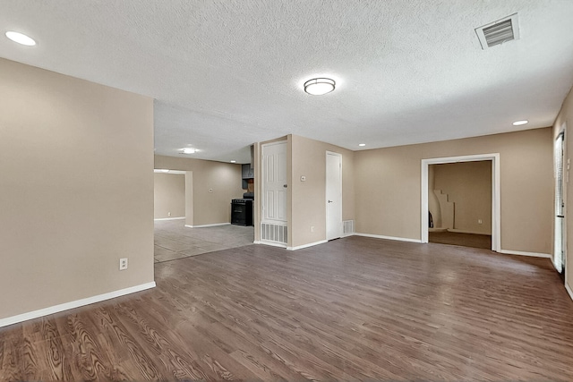 7121 Isleta Blvd SW Rear, Rear, Albuquerque, NM 87105 - unfurnished living room featuring baseboards, wood finished floors, recessed lighting, and a textured ceiling