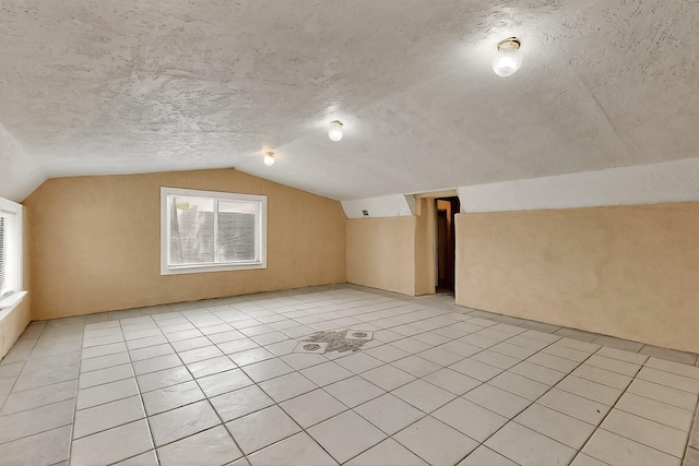 7121 Isleta Blvd SW Rear, Rear, Albuquerque, NM 87105 - additional living space with lofted ceiling, light tile patterned floors, and a textured ceiling