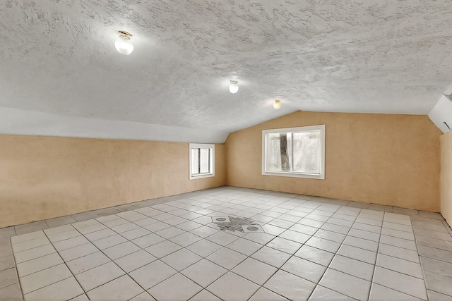 7121 Isleta Blvd SW Rear, Rear, Albuquerque, NM 87105 - additional living space featuring vaulted ceiling, light tile patterned floors, and a textured ceiling
