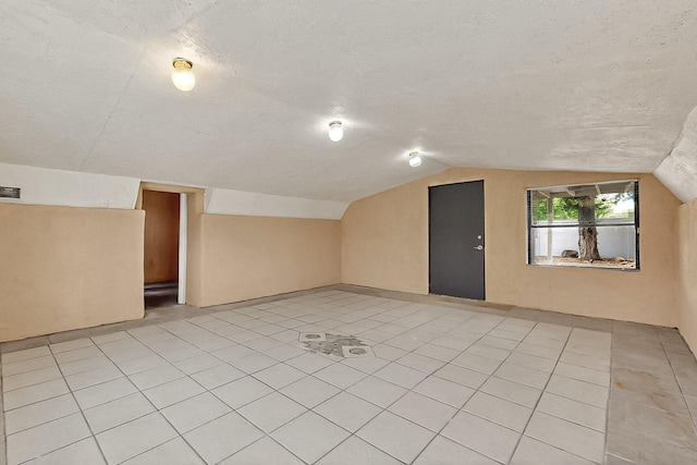 7121 Isleta Blvd SW Rear, Rear, Albuquerque, NM 87105 - bonus room with vaulted ceiling, light tile patterned flooring, and a textured ceiling