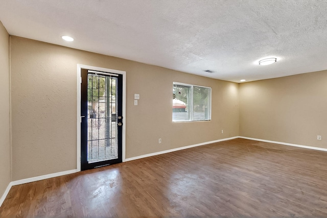 7121 Isleta Blvd SW Rear, Rear, Albuquerque, NM 87105 - spare room featuring wood finished floors, baseboards, and a textured ceiling