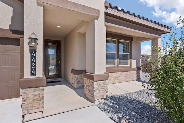 entrance to property with stucco siding and stone siding