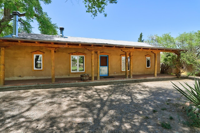 545 Atrisco Dr NW, Albuquerque, NM 87105 - back of property featuring a patio area and metal roof