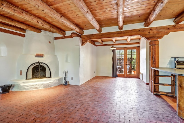 545 Atrisco Dr NW, Albuquerque, NM 87105 - unfurnished living room with beamed ceiling, brick floor, a fireplace, and wood ceiling