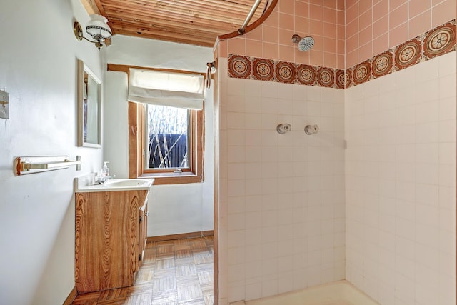 545 Atrisco Dr NW, Albuquerque, NM 87105 - bathroom with baseboards, tiled shower, and vanity