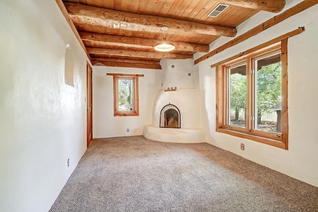 545 Atrisco Dr NW, Albuquerque, NM 87105 - unfurnished living room with carpet floors, visible vents, wooden ceiling, and beamed ceiling