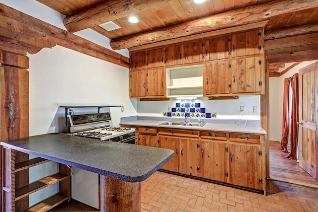 545 Atrisco Dr NW, Albuquerque, NM 87105 - kitchen featuring beam ceiling, a sink, brick floor, gas range oven, and wood ceiling