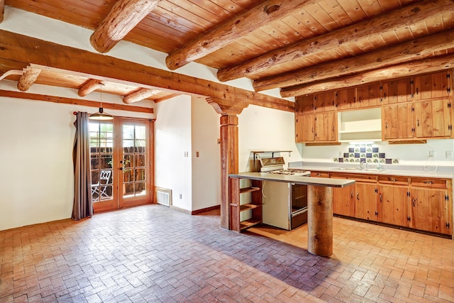 545 Atrisco Dr NW, Albuquerque, NM 87105 - kitchen featuring wood ceiling, visible vents, a sink, white range with gas cooktop, and brick floor