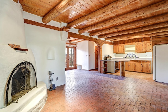 545 Atrisco Dr NW, Albuquerque, NM 87105 - unfurnished living room featuring visible vents, beamed ceiling, brick floor, wooden ceiling, and french doors