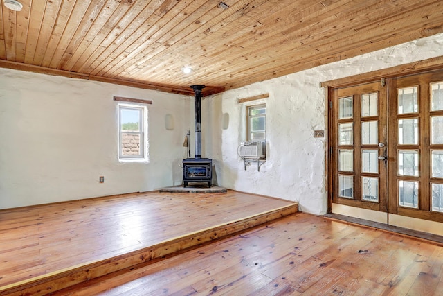 545 Atrisco Dr NW, Albuquerque, NM 87105 - unfurnished living room featuring wooden ceiling, a wood stove, and a wealth of natural light