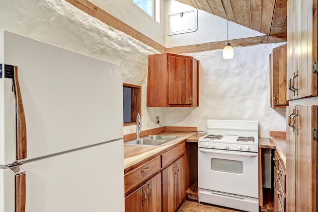 545 Atrisco Dr NW, Albuquerque, NM 87105 - kitchen featuring brown cabinetry, lofted ceiling, white appliances, light countertops, and a sink