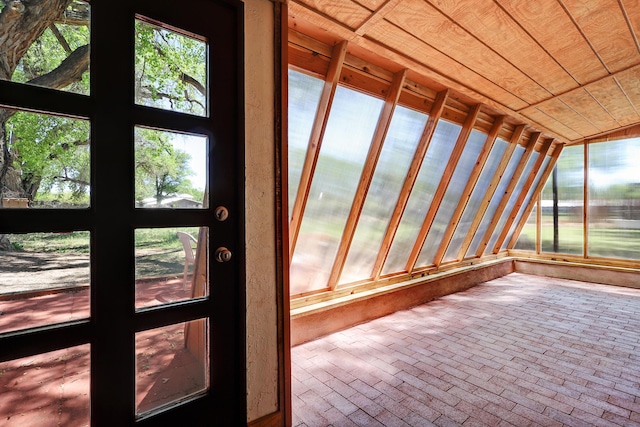 545 Atrisco Dr NW, Albuquerque, NM 87105 - unfurnished sunroom featuring wood ceiling and brick floor