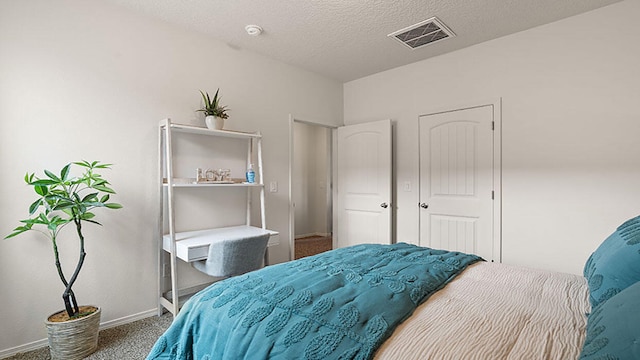 carpeted bedroom with a textured ceiling, baseboards, and visible vents