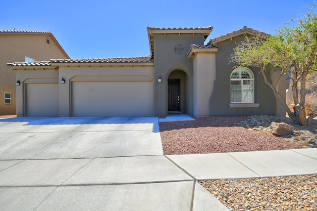7408 Molas Rd NW, Albuquerque, NM 87114 - mediterranean / spanish home featuring an attached garage, driveway, a tiled roof, and stucco siding