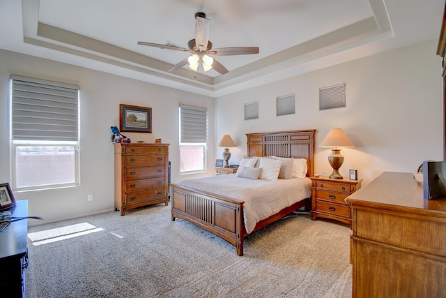 7408 Molas Rd NW, Albuquerque, NM 87114 - bedroom with a tray ceiling, light colored carpet, and ceiling fan