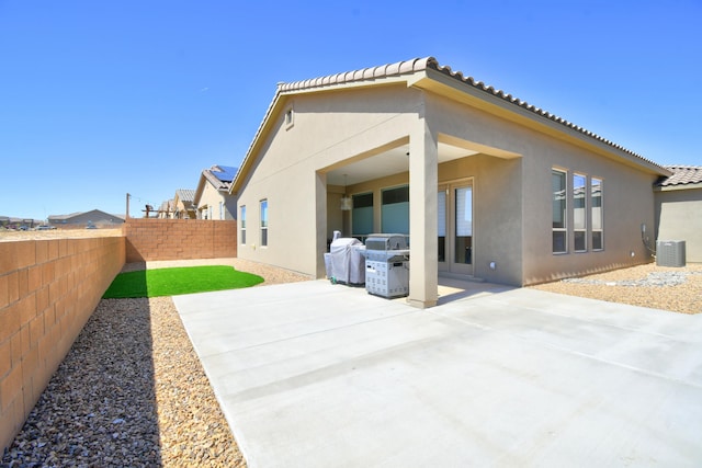 7408 Molas Rd NW, Albuquerque, NM 87114 - back of property featuring stucco siding, a fenced backyard, a patio area, and central air condition unit
