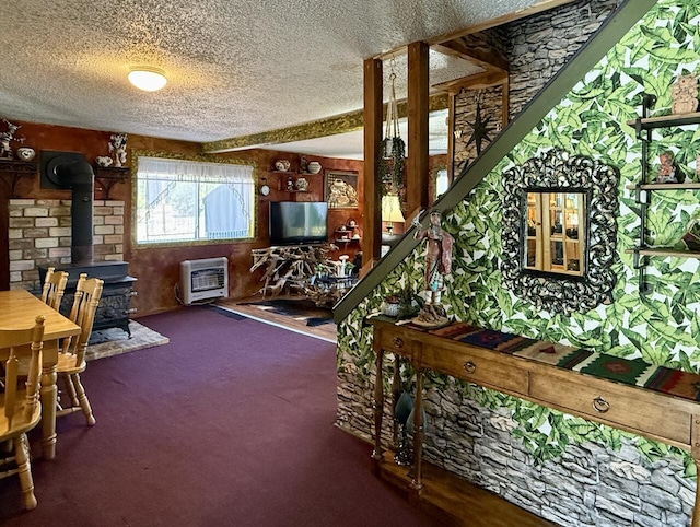 10 Cliffside Dr, Ramah, NM 87321 - interior space with carpet floors, a textured ceiling, heating unit, and a wood stove