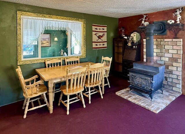 10 Cliffside Dr, Ramah, NM 87321 - carpeted dining space featuring a textured ceiling and a wood stove