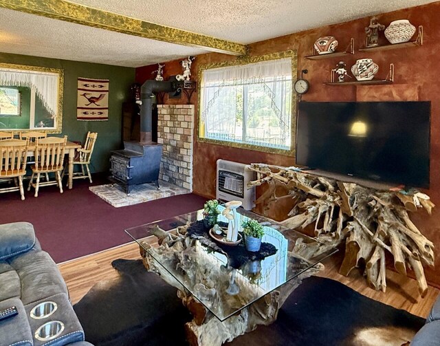 10 Cliffside Dr, Ramah, NM 87321 - living area with a wood stove, a textured ceiling, heating unit, and wood finished floors