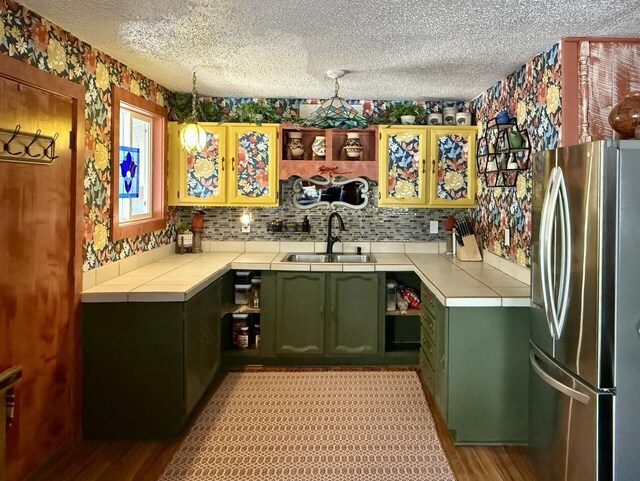 10 Cliffside Dr, Ramah, NM 87321 - bar with a sink, a textured ceiling, freestanding refrigerator, wallpapered walls, and light wood-type flooring
