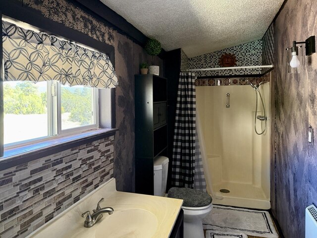 10 Cliffside Dr, Ramah, NM 87321 - bathroom featuring vanity, a textured ceiling, toilet, and a shower stall