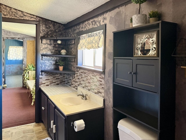 10 Cliffside Dr, Ramah, NM 87321 - bathroom featuring toilet, a textured ceiling, wallpapered walls, and vanity