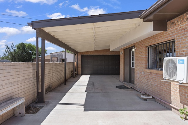 view of patio with fence, ac unit, and driveway