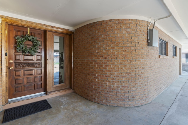 property entrance featuring brick siding