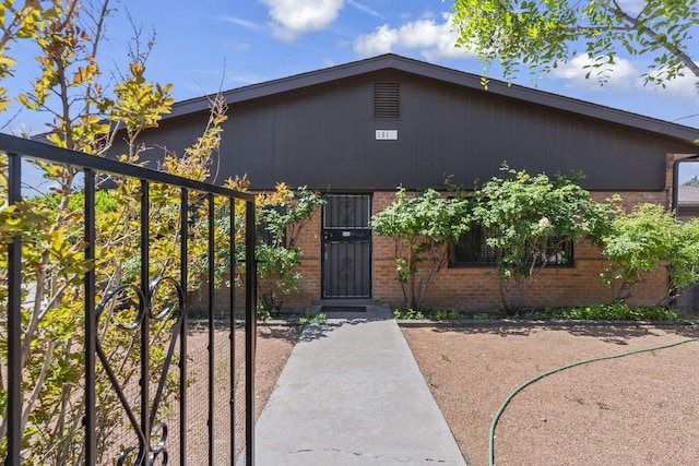 mid-century home featuring brick siding