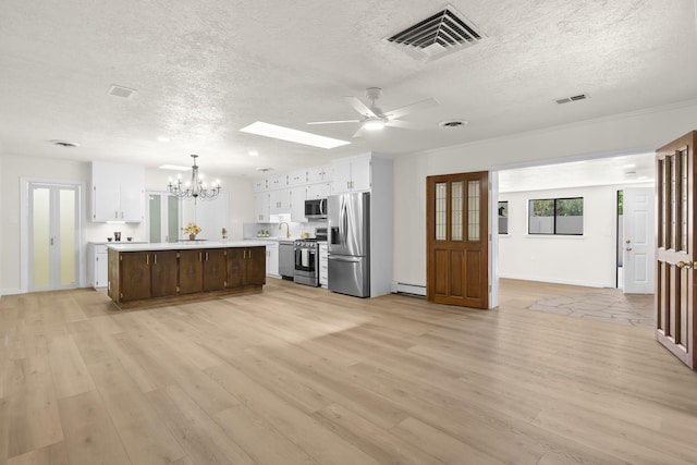 kitchen with visible vents, a textured ceiling, baseboard heating, and stainless steel appliances
