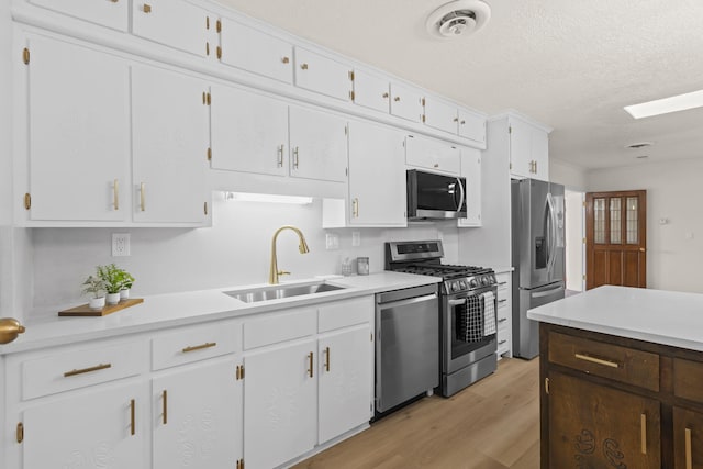 kitchen with a sink, appliances with stainless steel finishes, and light countertops