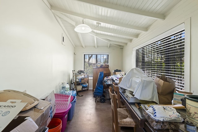 interior space with vaulted ceiling with beams and concrete floors