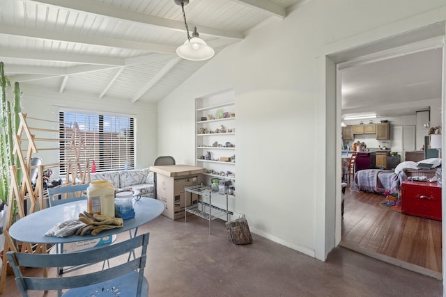 dining room featuring baseboards, finished concrete flooring, and vaulted ceiling with beams