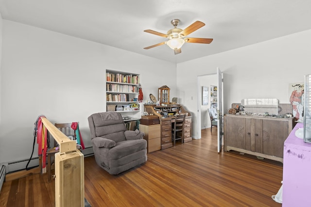 bedroom featuring a ceiling fan, a baseboard heating unit, and wood finished floors