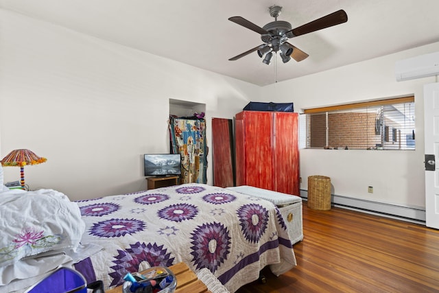 bedroom featuring wood finished floors, a wall mounted air conditioner, ceiling fan, and a baseboard heating unit
