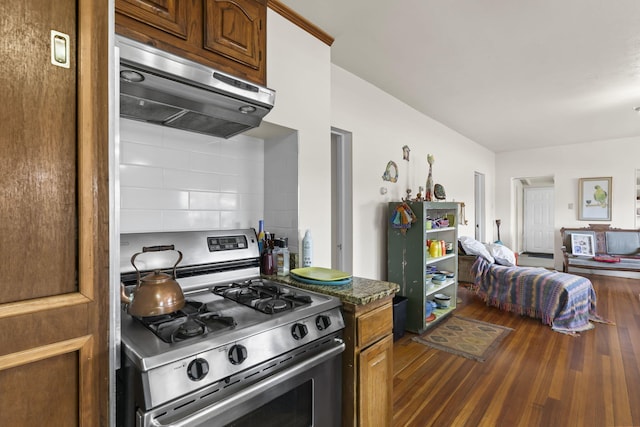 kitchen featuring brown cabinets, gas stove, dark wood finished floors, open floor plan, and range hood