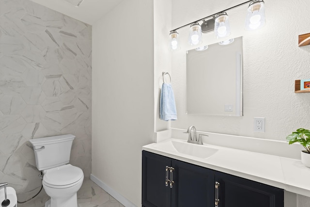 bathroom featuring vanity, marble finish floor, and toilet