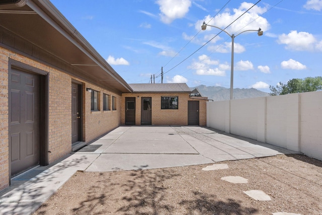 view of patio with a fenced backyard and a mountain view