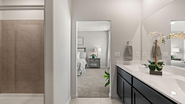 ensuite bathroom featuring double vanity, a sink, tile patterned flooring, and ensuite bath