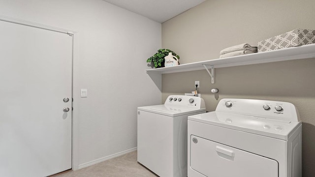 laundry room featuring baseboards, laundry area, and washer and clothes dryer